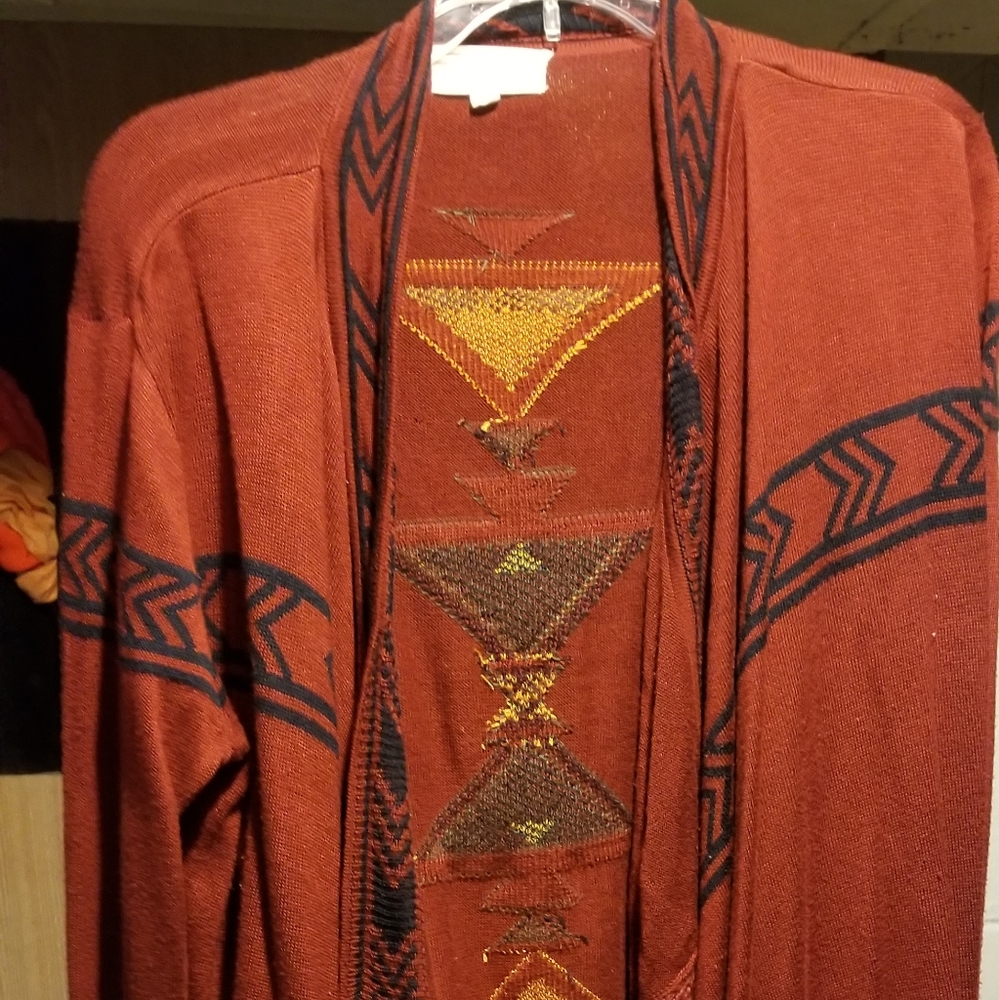 A long dark red orangish colored cardigan